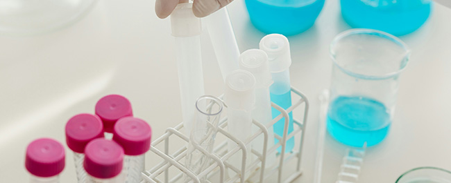 a row of test tubes in a wire rack